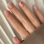 Close-up of baby chrome nails with a glossy finish perfect for a clean-girl aesthetic.