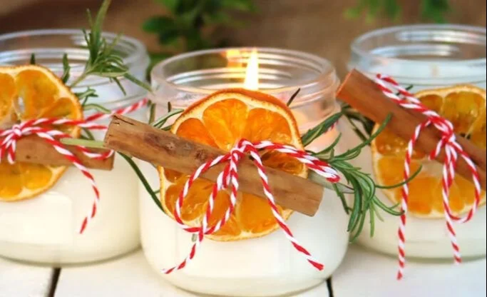 Homemade Christmas candles decorated and ready to be gifted for the holidays.