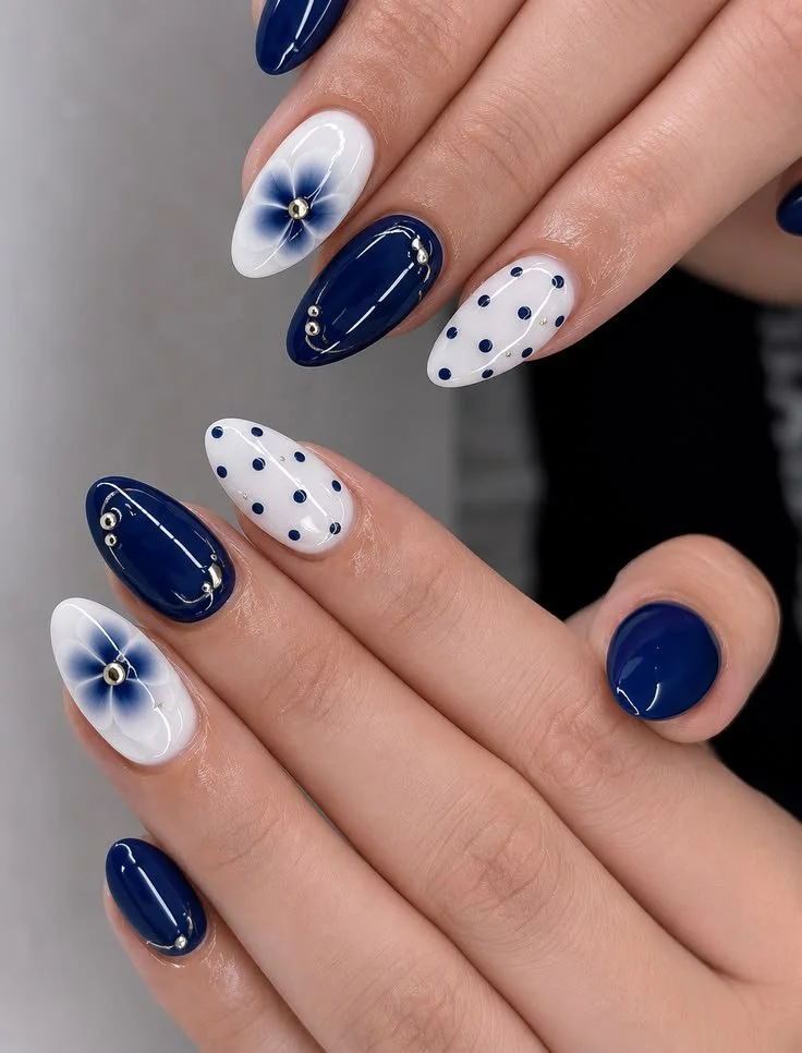 Elegant white and navy blue floral almond nails designed for busy moms.