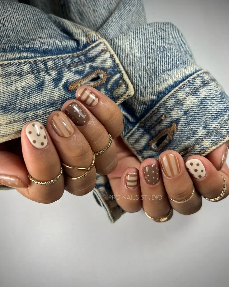 Fall 2024 manicure trends showcasing brown and white nails with simple designs.