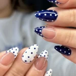 Blue and white polka dot nails with French tips design