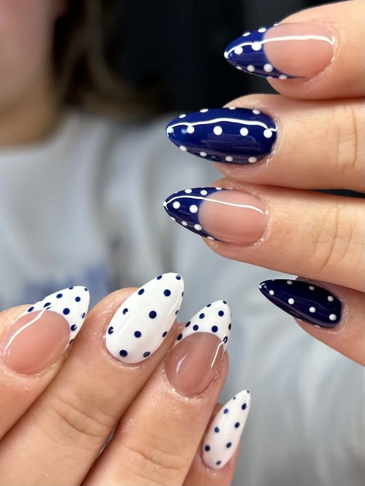 Blue and white polka dot nails with French tips design