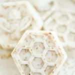 Handmade honey oatmeal soap shaped like bees and honeycombs with vanilla essential oil.