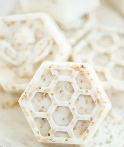 Handmade honey oatmeal soap shaped like bees and honeycombs with vanilla essential oil.