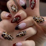 Handmade luxury press on nails with leopard print, 3D flowers, and rhinestones.