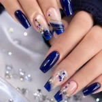 Stylish navy blue and rhinestone press-on nail inspiration design.