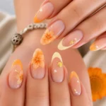 Vibrant orange floral press on nails with French tip design for summer vacations