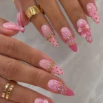 Stunning pink coquette 3D flower nails with polka dots for summer manicure