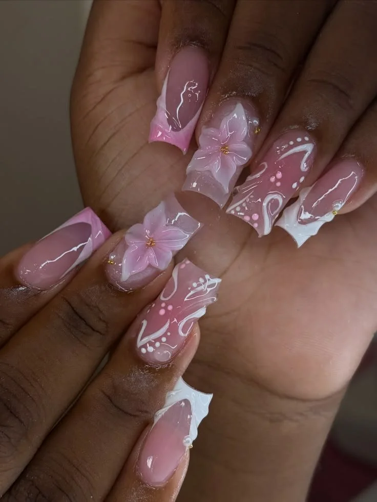 Pink French tip nails with flower designs in a DIY tutorial for beginners