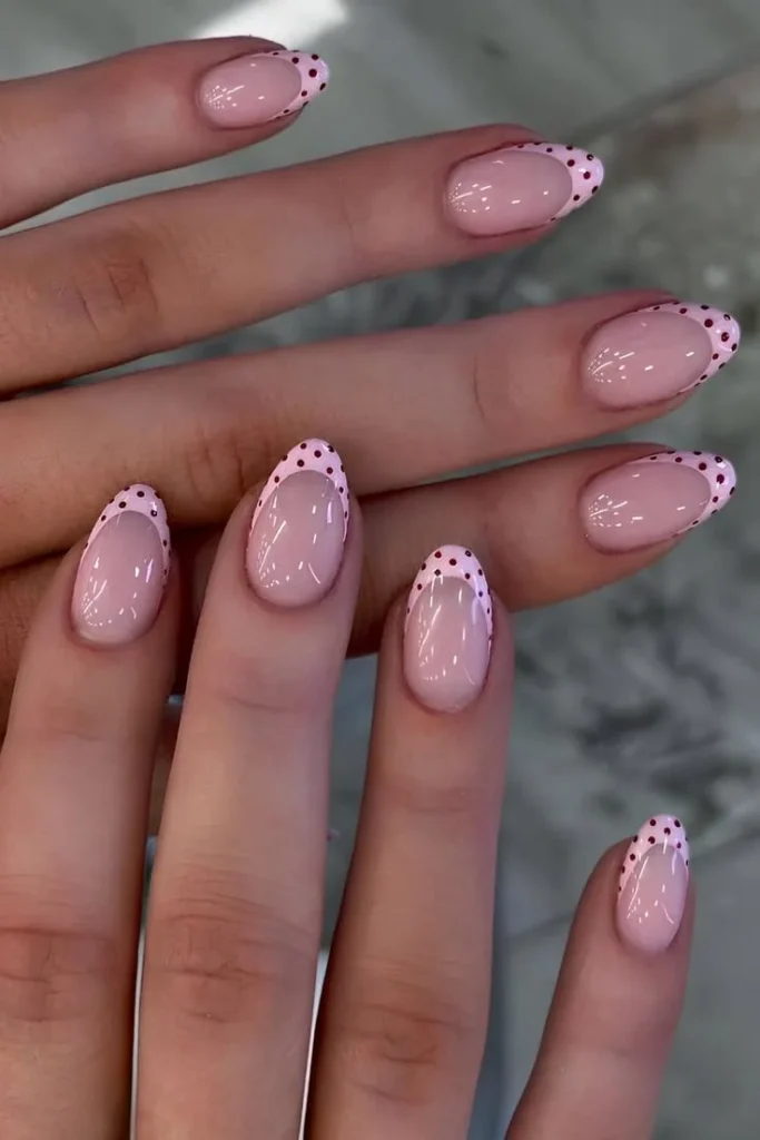 Pink nails design featuring dot French tips and polka dot acrylic nails.
