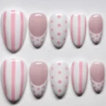 Pink and white polka dot and stripe press-on nails designed for a stylish look.