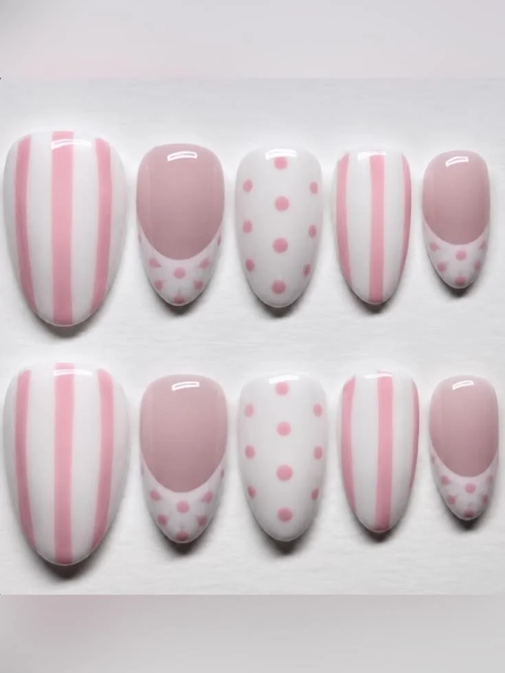 Pink and white polka dot and stripe press-on nails designed for a stylish look.