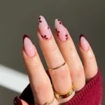 Beautifully designed flower nails in dark cherry shade with floral motifs