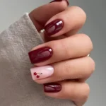 A beautiful display of short pink nails with stunning designs for moms.