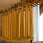 Homemade beeswax candles in cozy evening setting
