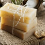 Homemade oatmeal and honey soap bars on a wooden surface