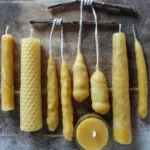 Homemade beeswax candles in varying sizes and shapes, ideal for beginners.