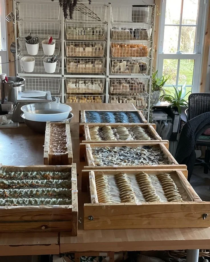 View of soap making process in the studio with essential oils and crafted soaps.