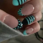 Stylish teal nails with intricate designs for a trendy look