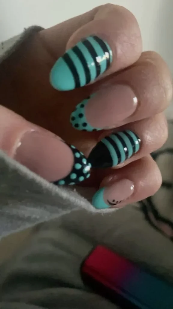 Stylish teal nails with intricate designs for a trendy look