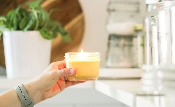 A collection of beautifully crafted homemade candles in various colors and shapes.