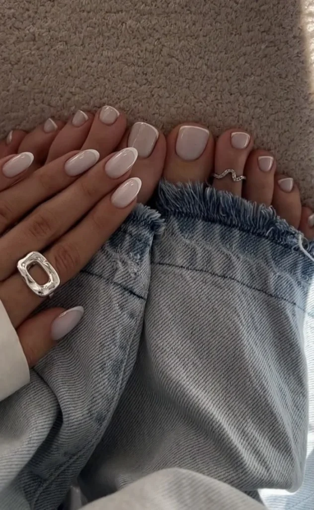 Milky white French tip nails with a clean minimal manicure for moms.