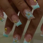 Tropical French tips nails featuring vibrant floral designs for a chic summer look.