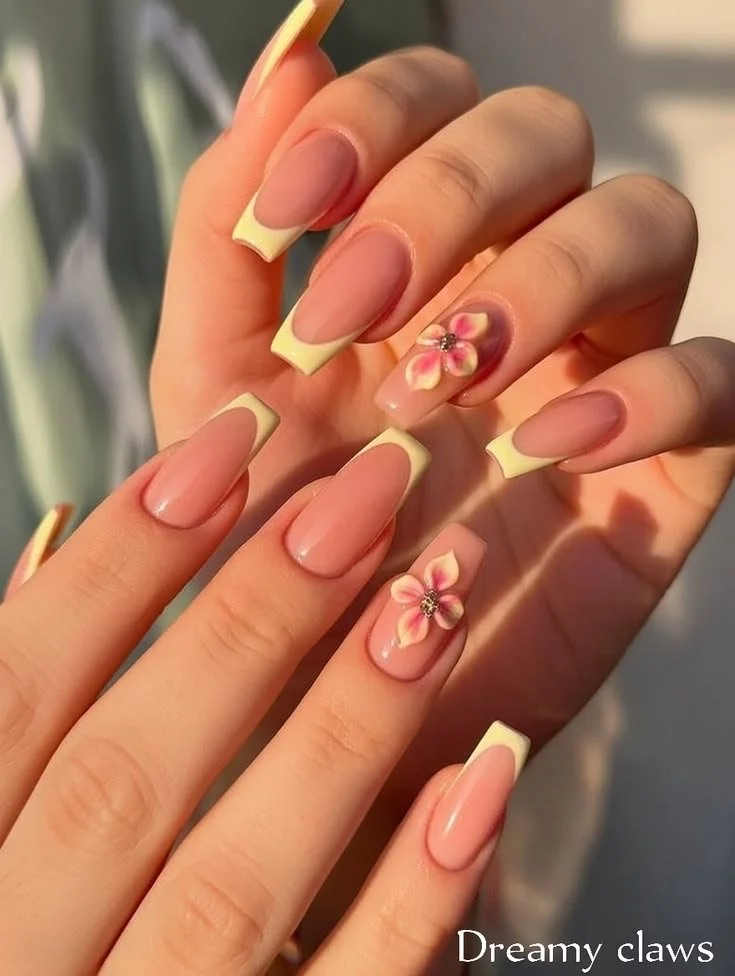 Yellow French tip nails with 3D flowers for vibrant summer nail art