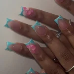 Colorful nail designs featuring French tips, bows, and blue-pink aesthetics.