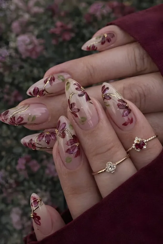 Autumn almond nails featuring a delicate fall flower design