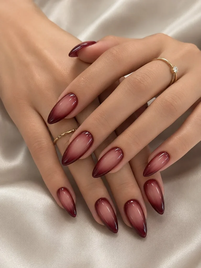 Black Cherry Aura Nails with glossy nude to wine ombre on almond-shaped nails