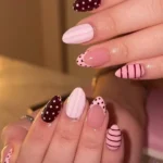 Burgundy and pink mix & match almond nails with dots and stripes design