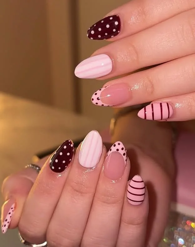 Burgundy and pink mix & match almond nails with dots and stripes design