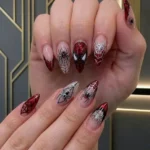 Stylish spider nails design featuring intricate patterns and colors.