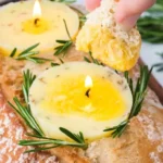 A garlic butter candle emitting a warm, inviting glow for home ambiance.