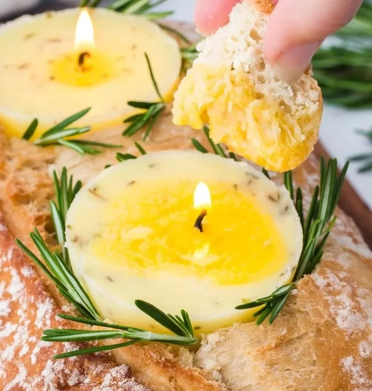 A garlic butter candle emitting a warm, inviting glow for home ambiance.