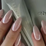 Glazed neutral pink almond nails showcasing a simple and elegant manicure.