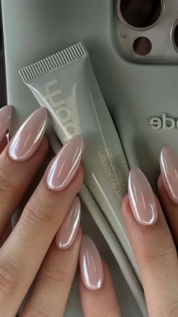 Glazed neutral pink almond nails showcasing a simple and elegant manicure.