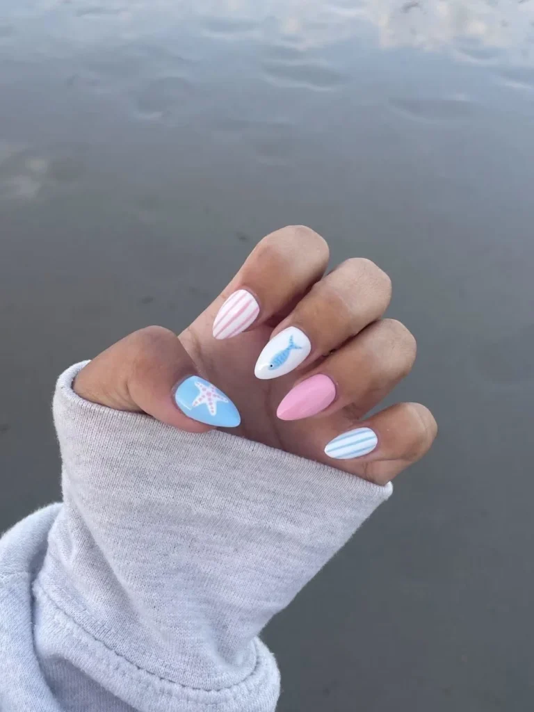 Hand painted nautical press on nails with blue and pink fish and starfish design