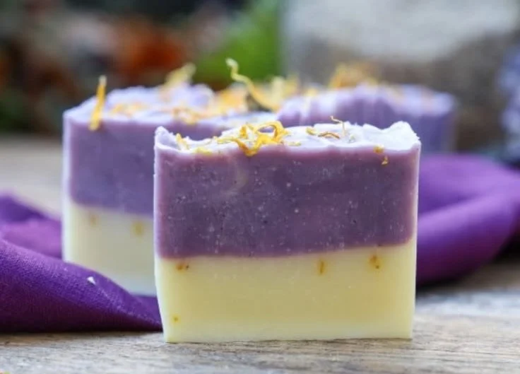 Homemade lemongrass lavender soap bar with fresh herbs and flowers