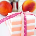 Variety of colorful homemade soaps arranged on a wooden surface