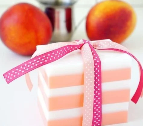 Variety of colorful homemade soaps arranged on a wooden surface