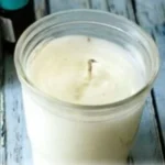 Homemade candles with essential oils displayed on a table for beginners