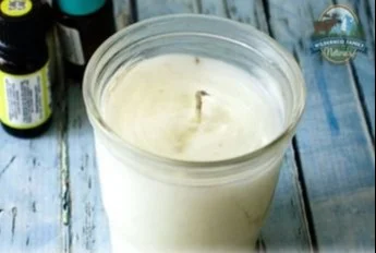 Homemade candles with essential oils displayed on a table for beginners