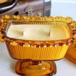Various unique containers for DIY candles with finished candles in them.