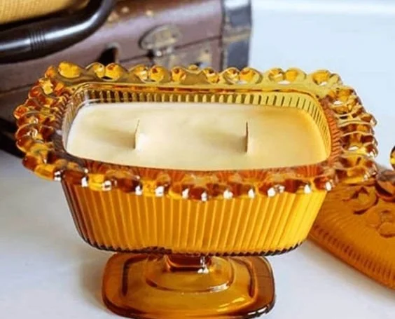Various unique containers for DIY candles with finished candles in them.