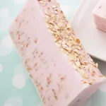A bar of homemade oatmeal soap with cherry almond fragrance