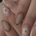 Beautiful oval nails featuring winter colors for 2025-2026 nail art ideas