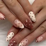 Colorful polka dot nails design on manicured hands