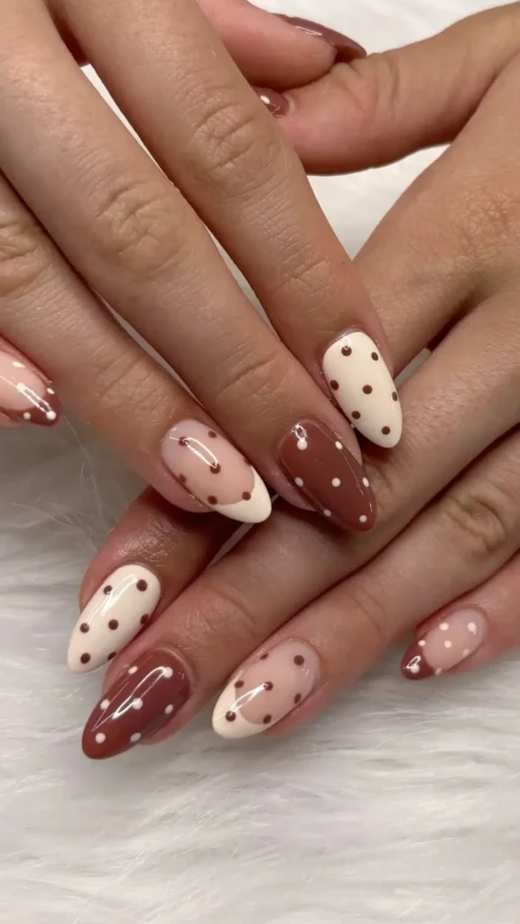 Colorful polka dot nails design on manicured hands